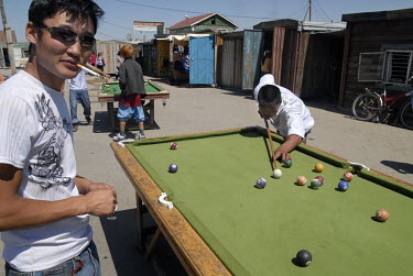 Men play open air pool in the Kharkhorin bazaar.