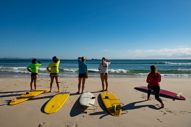 Female entrants wait to enter the water at a surf contest for local surfers at the Pass, a beach in Byron Bay, that has been running for over 20 years.   The Byron Bay community is at war with a propo...