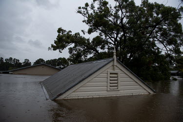 The roof of a house shows above the water in Windsor where over the previous weekend, the Hawkesbury River rose rapidly by more than 30 feet.