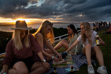 A group of young women from Brisbane picnic at the base of the Byron Bay Lighthouse, a popular location for sunset and sunrise.   The Byron Bay community is at war with a proposed Netflix reality TV s...