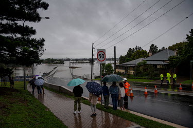 People look at the flooding in Windors where over the previous weekend, the Hawkesbury River rose rapidly by more than 30 feet.