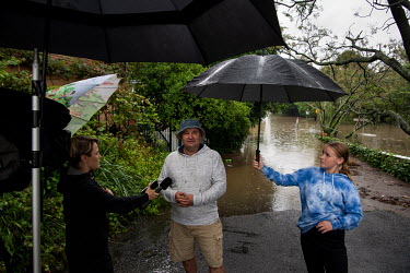 A local residents is interviewed for television newson the flooded streets in Windsor where over the previous weekend, the Hawkesbury River rose rapidly by more than 30 feet.