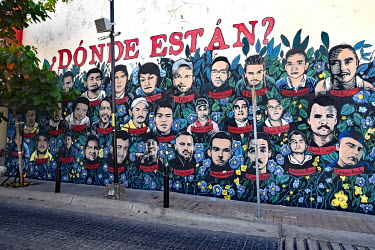 A wall mural featuring portraits of some of the disappeared people from the region with the slogan 'where are they'.