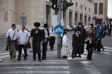 Orthodox Jews walking through the city as they make their way to celebrate Passover.
