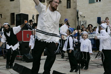 Orthodox Jews dance to a band playing to celebrate Passover.