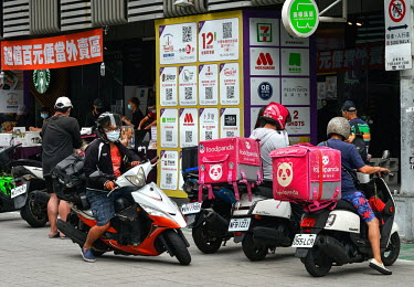 Food Panda delivery riders parked outside a popular food court in central Taipei. Meal delivery services such as Food Panda and Uber Eats have seen a boom in demand ever since Taiwan entered Level 3 (...