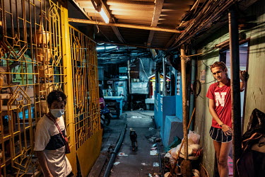 Residents of the sprawling Klong Toei slum community chat in the evening in the areas narrow lanes where social distancing is particularly hard to comply with.