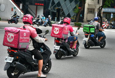 Food delivery riders in central Taipei where meal delivery services such as Food Panda and Uber Eats have seen a boom in demand ever since Taiwan entered Level 3 (of 4) COVID-19 restrictions following...