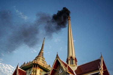Unusually black smoke is seen coming out of the chimney of a temple cremation furnace caused by plastic that wraps the body of COVID-19 victims being cremated and the increased temperature that COVID-...