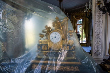 An ornate clock covered in plastic sheeting at Villa La Grange in Parc de La Grange, the location for the Biden - Putin summit. The site is being prepared with officials, technicians, restorers and ga...