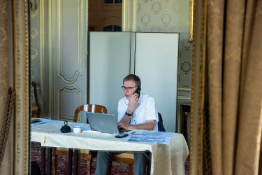 A journalist at work at Villa La Grange in Parc de La Grange, the location for the Biden - Putin summit. The site is being prepared with officials, technicians, restorers and gardeners hard at work, p...