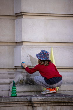 Children 'clean' the Science Museum of dirty money from Shell during a protest by scientists and their families against Shell's sponsorship of 'Our Future Planet', an exhibition advocating techno-fixe...
