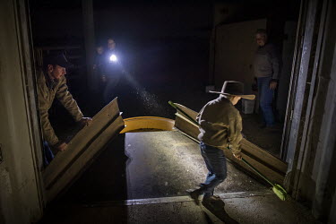 The Tink family hunt mice most evenings as the region is inundated with mice. Farmer Colin Tink (far right) designed the giant mouse trap from a empty container with some grain as bait, some bits of c...