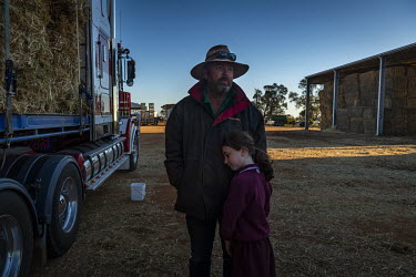 Farmer Greg Younghusband with his daughter Caitlin Younghusband (8) prepare a truck carting hay that has not been too badly damaged by mice. They will sell these to farmers as feed for their cattle. G...