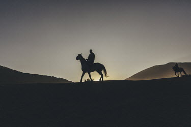Spectators arrive on horseback to the Ethno-Village at the World Nomad Games.