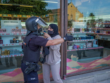 A Muslim woman argues with a police officer during a demonstration against the far right political party VOX, outside the hotel where its leader, Santiago Abascal planned to lead a rally. Abascal has...
