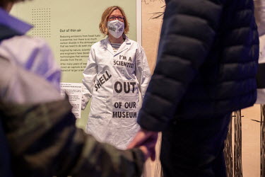 A scientist chained to a display at the 'Our Future Planet' exhibition at the Science Museum in South Kensington talks to visitors about their protest which is against Shell's sponsoring of the exhibi...