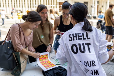Visitors engage with scientists, who are part of the Extinction Rebellion climate change action group, as they protest Shell's sponsorship of 'Our Future Planet', an exhibition advocating techno-fixes...