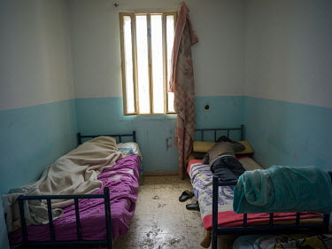 Young Moroccan migrants sleep inside the abandoned prison of Ceuta, where they and another 30 youths have been staying and trying to evade police after illegally entering the Spanish exclave of Ceuta...