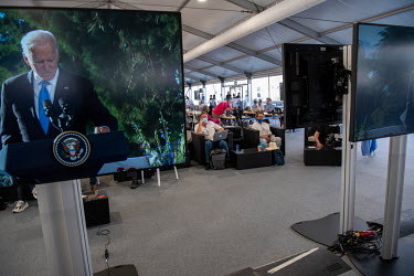 Members of the world's press gathered in the media centre watch a television broadcast of Joe Biden speaking at the Joe Biden/Vladimir Putin summit meeting which was taking place at nearby Villa La Gr...