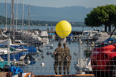 Members of security patrol a yacht marina on Lake Geneva during the Joe Biden/Vladimir Putin summit meeting at nearby Villa La Grange.