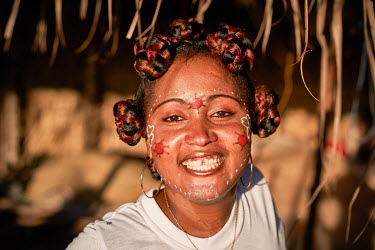 A young woman with a painted face, performs a dance in Beanjavilo, a village set among mangroves in the western coastal region.
