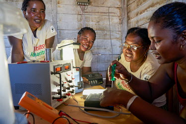 'Solar Mamas' repairing solar lights in Ambakivao, a village set among mangroves in the western coastal region.  Dubbed the 'Solar Mamas', these women were the first in their village to join a program...