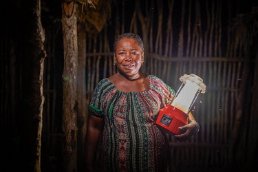 'Solar Mama' Kingaline (44) with a solar lamp in Ambakivao, a village set among mangroves in the western coastal region of Madagascar. Dubbed the 'Solar Mamas', these women were the first in their vil...