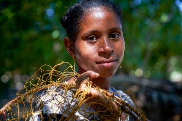 A fishing woman in a village set among mangroves in the western coastal region.