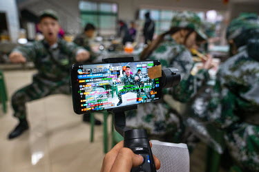 Jiang Bo, a 25-year-old live-streamer, at a military boot camp for a broadcasting program. Nai Nai's fans are mostly Chinese men between 15 and 30 years old who post messages and virtual gifts, visibl...
