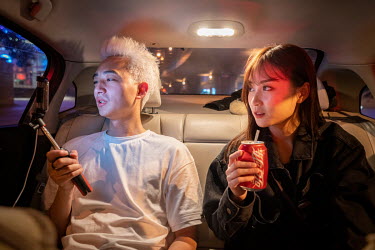 Nai Nai, a 23-year-old live-streamer sits in a car with her friend 'Big Uncle'. Nai Nai's fans are mostly Chinese men between 15 and 30 years old who post messages and virtual gifts, visible to everyo...