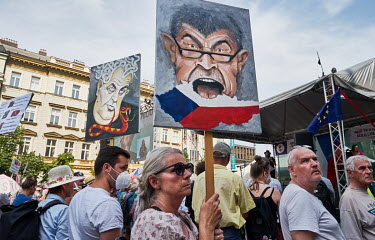 A protester holds a placard with an image of Czech Prime Minister Andrej Babis during a demonstration on Wenceslas Square where thousands of people gathered to demand his resignation.