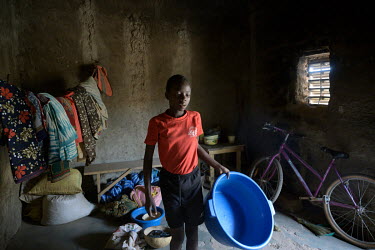 Rachel, a pupil at the Denro associative school, with her precious bicycle, supplied to all pupils at the school, parked in her home. The Denro de Koudougou association offers completely free educatio...