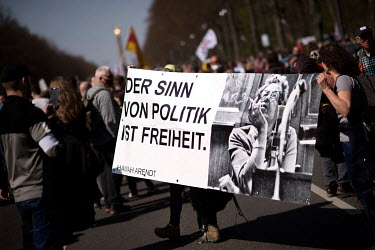 Protestors from the anti-lockdown Querdenker Movement with a banner featuring Hannah Arendt.