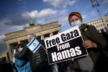 A protestor with the flag of Israel and a placard that reads: 'Free Gaza From Hamas', during a rally of the German Jewish community and political parties in front of the Brandenburger Gate in solidari...
