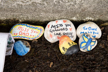 Painted memorial stones left at the base of the National Covid Memorial Wall on London's South Bank faces the British Parliament on the opposite side of the Thames. More than 1000 volunteers painted t...
