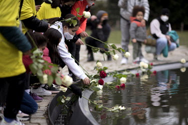 People place white and red roses in the pond surrounding the memorial to Roma and SInti on International Roma Day as the 220,000 to 1,500,000 Sinti and Roma murdered by the Nazis are remembered.