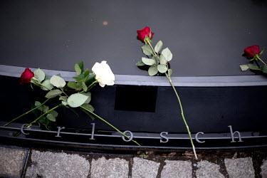 White and red roses left in the pond surrounding the memorial to Roma and SInti on International Roma Day as the 220,000 to 1,500,000 Sinti and Roma murdered by the Nazis are remembered.