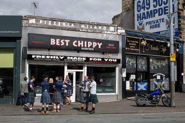 Disappointed 'Tartan Army' fans gather outside 'Best Chippy' after watching the Scottish national football team lose 2-0 to the Czech Republic at Hampden Stadium in their first game at the UEFA Euro 2...