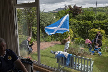 Alan Paterson (inside) and his son Kenny (in garden) are members of the 'Tartan Army', the name for fans of Scotland's national football team. Alan has passed on his passion to son Kenny who is taking...