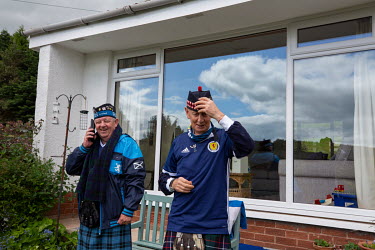 Alan Paterson (R) and friend Jim Torrance, both members of the 'Tartan Army', the name for fans of Scotland's national football team. They are both dressed in kilts and Scottish football team jerseys.