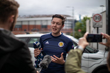 Gordon Scheach, a member of the Tartan Army who runs thetartanscarf podcast, talking with fellow Scotland fans outside Hampden Stadium, where Scotland played the Czech Republic in their first game at...