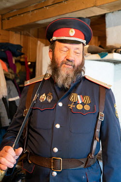 A forestry department ranger working in the area around Lake Baikal wearing a dress uniform.  Crowned the 'Jewel of Siberia', Lake Baikal is the world's deepest lake, and the biggest lake by volume, h...