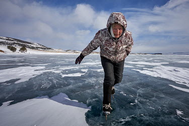 Baba Luba (Grandma Luba) skates on the frozen surface of Lake Baikal.   Crowned the 'Jewel of Siberia', Lake Baikal is the world's deepest lake, and the biggest lake by volume, holding 20% of the wo...