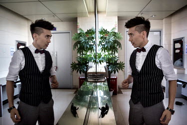 Uighur pop sensation Ablajan checks himself in a mirror backstage during rehearsals for a planned live webcast concert scheduled for that afternoon. However, the performance, to be held at a state own...