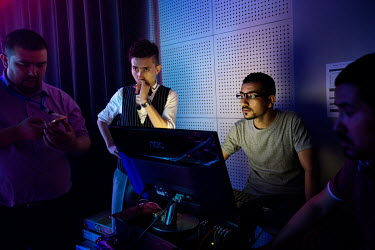Uighur pop sensation Ablajan (left) checks a computer with his sound engineers during rehearsals for a planned live webcast concert scheduled for that afternoon. However, the performance, to be held a...