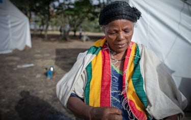 Yeshamie Destage, wearing her locally made shawl in the colours of the Ethiopian national flag, in a camp of internally displaced people following an armed attack on the town of Ataye destroyed more t...