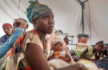 Hiwot (left) with her baby Tarikua (six months) in a camp for internally displaced people. Tarikua was born in the local hospital that was one of the many buildings destroyed following an armed attack...
