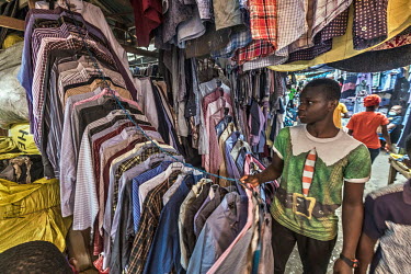Second-hand shirts, many with the price labels of the United Kingdom charity shops they were once on sale in still attached, on stall in Kantamanto market, West Africa's largest market for second-hand...