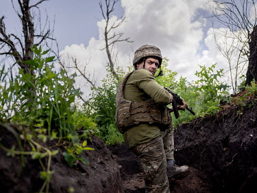 Victor (20) keeps watch from a trench where Ukrainian government forces are just 200 metres from their enemy, Russian-backed separatists. At all times the soldiers must be alert as snipers are very ac...